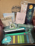 Moonlit Garden Journaling Bundle contents including sage green pens, butterfly sticky notes, moonlit bookmark, highlighter, glue tape, and journaling accessories